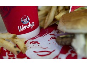 The Wendy's Co. logo is seen on a cup displayed for a photograph at a restaurant location in Daly City, California.