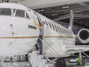 A worker shines up Bombardier's Global 7500 at the company's finishing plant in Montreal, Wednesday, Dec. 19, 2018.