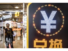 The currency symbol for the Chinese yuan is displayed at a currency exchange store in Hong Kong, China, on Wednesday, Aug. 12, 2015. The yuan sank for a second day, spurring China's central bank to intervene as the biggest rout since 1994 tested the government's resolve to give market forces more sway in determining the exchange rate. Photographer: Bloomberg/Bloomberg