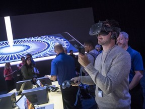 An attendee wears a HTC Corp. Vive virtual reality (VR) headset during the Apple Worldwide Developers Conference (WWDC) in San Jose, California, U.S., on Monday, June 5, 2017. The conference aims to inspire developers from around the world to turn their passions into the next great innovations and apps that customers use every day across iPhone, iPad, Apple Watch, Apple TV and Mac.