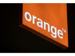 An illuminated logo hangs inside an Orange SA mobile phone store in Blagnac near Toulouse, France, on Wednesday, July 26, 2017. Orange is looking for European acquisitions outside of telecommunications that could cost as much as several billion euros, and recently considered buying German metering company Ista International GmbH, according to people close to the matter. Photographer: Balint Porneczi/Bloomberg