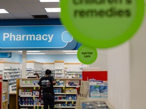 A pharmacist assists a customer at a CVS Health Corp. store in downtown Los Angeles, California, U.S., on Friday, Oct. 27, 2017. The prospect of Amazon.com Inc. entering the healthcare business is beginning to cause far-reaching reverberations for a range of companies, roiling the shares of drugstore chains, drug distributors and pharmacy-benefit managers, and potentially precipitating one of the biggest corporate merger deals this year.