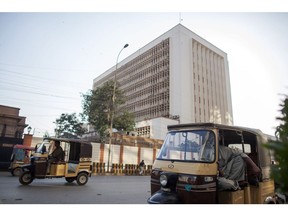 Auto rickshaws travel past the State Bank of Pakistan building in Karachi, Pakistan, on Thursday, Dec. 14, 2017. Pakistan's rupee weakened to a record low after the central bank continued to ease its grip on the currency amid mounting economic pressure and speculation that the country may need International Monetary Fund support. Photographer: Asim Hafeez/Bloomberg