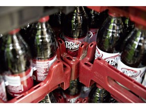 Bottles of Dr Pepper Snapple Group Inc. Dr Pepper brand soda are displayed for sale at a supermarket in Princeton, Illinois, U.S., on Monday, Jan. 29, 2018. JAB Holding Co.'s Keurig Green Mountain Inc. business, known for its single-serve coffee brewers, agreed today to take control of Dr Pepper Snapple Group in a deal that will pay $18.7 billion in cash to shareholders and assemble a massive beverage distribution network in the U.S.