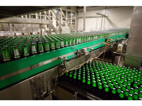 Green bottles of Carlsberg beer move along the production line following the labeling process at the Baltika Breweries LLC plant, operated by Carlsberg A/S, in Saint Petersburg, Russia, on Thursday, May 10, 2018. A slowdown in Russian demand for beer as international sanctions threaten the country's economy is weighing on Danish brewer Carlsberg's sales.
