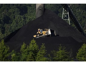 A Caterpillar Inc. bulldozer operates on a coal mound at the Alpha Natural Resources Inc. Mammoth Preparation Plant in London, West Virginia, U.S., on Wednesday, July 18, 2018. The coal industry is likely to confront a much less threatening emissions rule from President Donald Trump's EPA, which is seeking to repeal and replace the Obama-era Clean Power Plan.