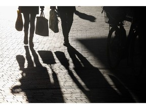 Shoppers cast shadows as they walk through the Kobmagergade pedestrianized shopping street in Copenhagen, Denmark, on Thursday, Jan. 3, 2019. For the first time in almost three years, the central bank of Denmark has bought kroner to support its euro peg through a direct intervention in the currency market. Photographer: Luke MacGregor/Bloomberg