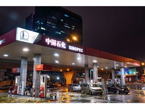 Vehicles refuel at a China Petroleum & Chemical Corp. (Sinopec) gas station at night in Hong Kong, China, on Saturday, March 23, 2019. Sinopec aims to raise spending to the highest since 2014, joining state-owned peers in their mission to churn out more domestic oil and gas to ease China's reliance on imports.