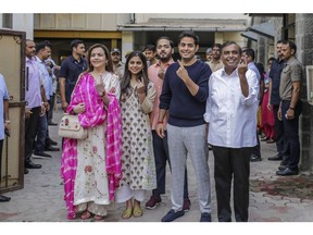 Mukesh Ambani, chairman and managing director of Reliance Industries Ltd., from right, his sons Akash Ambani and Anant Ambani, his daughter Isha Ambani and his wife Nita Ambani pose for a photograph at a polling station during the fourth phase of voting for national elections in Mumbai, India, on Monday, April 29, 2019. India's financial capital went to the polls today with billionaires, celebrities and slum dwellers among those lining up to elect lawmakers they hope will fix Mumbai's crumbling and stretched infrastructure.