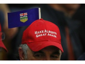 An attendee wears a "Make Alberta Great Again" hat while Peter Downing, co-founder of Wexit, not pictured, speaks during a rally at Notre Dame High School in Calgary, Alberta, Canada, on Saturday, Nov. 16, 2019. Canada is experiencing its own separatist movement, pitting the oil-rich west against the administrative centers of the east. Photographer: Leah Hennel/Bloomberg