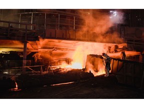 A worker in protective clothing monitors the blast furnace at the Liberty Steel plant in Galati, Romania, on Tuesday, Dec. 3, 2019.
