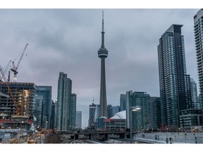 A residential building stands under construction in front of the CN tower in downtown Toronto, Ontario, Canada, on Sunday, Feb. 16, 2020. A shrinking supply of available homes for sale in Canada's largest city continued to drive prices higher last month, bringing annual increases to the strongest in more than two years. Photographer: Brett Gundlock/Bloomberg