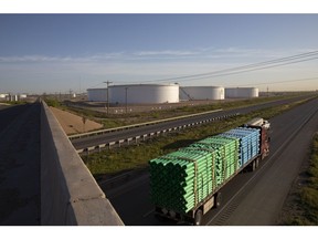 A truck passes crude oil storage tanks outside Midland, Texas, U.S, on Friday, April 24, 2020.  Photographer: Matthew Busch/Bloomberg