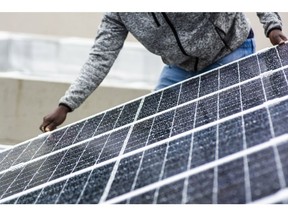 A worker installs solar panels onto the roof of a residential property in Johannesburg, South Africa, on Friday, Mar. 13, 2020. The coronavirus lockdown will cause the biggest drop in energy demand in history, with only renewables managing to increase output through the crisis. Photographer: Waldo Swiegers/Bloomberg