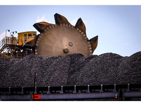 A bucket-wheel reclaimer stands next to a pile of coal at the Port of Newcastle in Newcastle, New South Wales, Australia, on Monday, Oct. 12, 2020. Prime Minister Scott Morrison warned last month that if power generators don't commit to building 1,000 megawatts of gas-fired generation capacity by April to replace a coal plant set to close in 2023, the pro fossil-fuel government would do so itself.