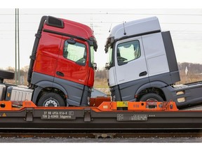 New haulage trucks loaded onto a train at the customer delivery center outside the Daimler AG truck factory in Woerth, Germany, on Thursday, Feb. 4, 2021. Daimler is moving ahead with plans for an initial public offering of its sprawling heavy-truck unit in what could be one of Germany's largest share sales ever.