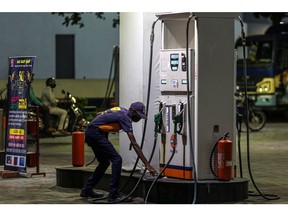 An attendant works at an Indian Oil Corp. gas station in Bengaluru, India, on Thursday, March 4, 2021. India's record pump prices of gasoline and diesel are the newest threat to the economy's nascent recovery, as high local taxes on retail fuel risk fanning inflation and driving a wedge between the objectives of fiscal and monetary policy makers.