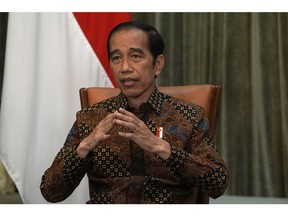 Joko Widodo, Indonesia's president, gestures as he speaks during an interview at Presidential Palace in Jakarta, Indonesia, on Wednesday, April 7, 2021. President Widodo is backing a push to expand Bank Indonesia's mandate to include support for the economy, throwing his public support behind a legislative move that some analysts see as risking the central bank's independence.