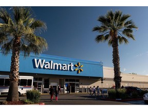 Shoppers walk outside a Walmart store in San Leandro, California, U.S., on Thursday, May 13, 2021. Walmart Inc. is expected to release earnings figures on May 18.