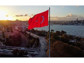 A Turkish flag by the Bosphorus strait during the evening sunset in Istanbul, Turkey, on Monday, Oct. 4, 2021. Turkey's consumer inflation accelerated in September, driven by a surge in the cost of energy. Photographer: Moe Zoyari/Bloomberg