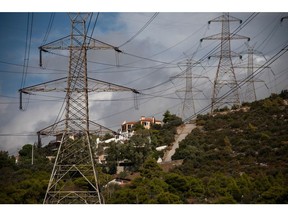 Electricity transmission pylons near residential homes in Gerakas suburb, northeast of Athens, Greece, on Tuesday, Oct. 12, 2021. European Union leaders are poised to authorize next week emergency measures by member states to blunt the impact of the unprecedented energy crisis on the most vulnerable consumers and companies.