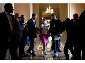Senator Joe Manchin, a Democrat from West Virginia, center left, speaks with Senator Kyrsten Sinema, a Democrat from Arizona, while departing Senate Democrat policy luncheons at the U.S. Capitol in Washington, D.C., U.S., on Tuesday, Nov. 16, 2021. The non-partisan Congressional Budget Office said its full cost estimate of the White House's signature tax and spending bill might not be ready until Friday, threatening to push a planned House vote on the legislation to the weekend or later. Photographer: Stefani Reynolds/Bloomberg
