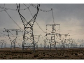 Transmission towers supporting ultra-high voltage power lines near a solar farm in Qinghai province. Photographer: Qilai Shen/Bloomberg