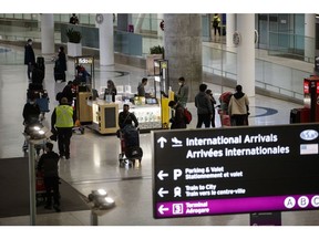 Travelers at Toronto Pearson International Airport (YYZ) in Toronto, Ontario, Canada, on Thursday, Dec. 16, 2021. Justin Trudeau's government is asking Canadians to avoid non-essential trips to other countries over the next month as the spread of the omicron Covid-19 variant accelerates. Photographer: Cole Burston/Bloomberg