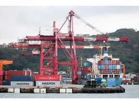 Gantry cranes and a container ship at the Port of Keelung in Keelung, Taiwan, on Friday, Jan. 7, 2022. Taiwan exports extended their double-digit growth for a tenth month, with shipments from the island in 2021 smashing all records due to soaring demand for technology products and components. Photographer: I-Hwa Cheng/Bloomberg