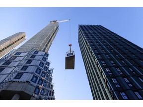 A crane lifts a section of apartment being fitted into position at a construction site in Croydon, Greater London, U.K., on Monday, Jan. 17, 2022. Inflation figures for the U.K., due on Wednesday, are likely to hold steady in December, before peaking in April at around 6.5%.