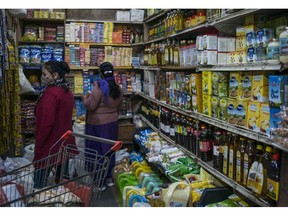 Customers browse goods at a store on the outskirts of New Delhi, India, on Tuesday, Feb. 8, 2022. Global food prices jumped toward a record last month, further adding to the surging cost of living for consumers.