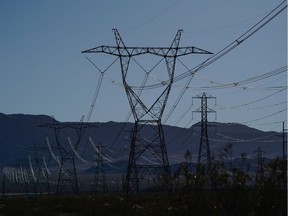 Power lines and transmission towers near the Ivanpah Solar Electric Generating System in the Mojave Desert in San Bernardino County, California, U.S., on Saturday, Feb. 19. 2022. California aims to end greenhouse gas emissions from its electricity grid by 2045.
