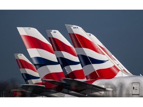 The British Airways livery on the tail fins of passenger aircraft at London Heathrow Airport. Photographer: Chris J. Ratcliffe/Bloomberg