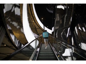A delivery man walks up an escalator in Sydney, Australia, Monday Feb. 28, 2022. Australia is due to release gross domestic product (GDP) figures on March 2.  Photographer: Brent Lewin/Bloomberg