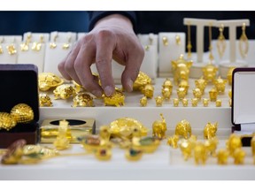 An employee arranges a turtle figure made of gold at the Korea Gold Exchange store in Seoul, South Korea, on Wednesday, March 2, 2022. Gold extended gains as investors weighed mounting risks to global growth from sanctions on Russia in the wake of its invasion of Ukraine. Photographer: SeongJoon Cho/Bloomberg