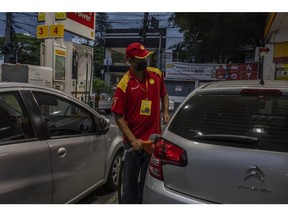 A worker refuels a vehicle at a Shell gas station in Sao Paulo, Brazil, on Thursday, March 10, 2022. The war between Russia and Ukraine has changed the dynamics of the international fuel market. The shortage of supply has thrown small importers in Brazil off track, and large companies are also feeling the decline in product supply, especially in the diesel oil segment, the Rio Times reports. Photographer: Victor Moriyama/Bloomberg