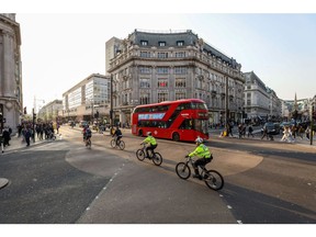 Police officers cross Oxford Circus on bicycles in central London, U.K., on Thursday, March 24, 2022. The Office for National Statistics are due to release the latest U.K. retail sales figures on Friday.
