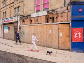 Residents pass boarded-up closed businesses in Weston-super-Mare, U.K., on Tuesday, April 12, 2022. U.K. inflation surged to 7% last month, a fresh three-decade high that worsens a cost of living crisis threatening to derail the nation's economic recovery.