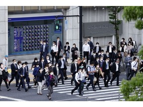 Pedestrians in front of a branch of Mizuho Securities Co., a unit of Mizuho Financial Group Inc., in Tokyo, Japan, on Monday, April 25, 2022. Mizuho Securities is scheduled to release earnings figures on April 28. Photographer: Kiyoshi Ota/Bloomberg