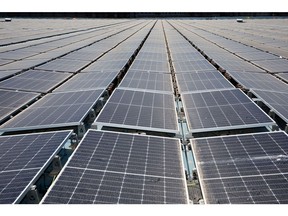 Solar panels which form part of the floating solar farm, operated by EDPR, during preparations for operational use in Alqueva, Portugal, on Tuesday, June 7, 2022. EDPR, the renewables arm of Portugal's main utility EDP, will pay for the electricity generated at a floating solar project it bid to build in an auction, without any compensation in return. Photographer: Goncalo Fonseca/Bloomberg