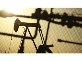 An oil pump jack at the New Harmony Oil Field in Grayville, Illinois. Photographer: Luke Sharrett/Bloomberg