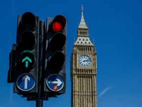 Traffic lights near Elizabeth Tower, also known as Big Ben, at the Palace of Westminster, the meeting place of the Houses of Parliament, in London, UK, on Monday, June, 20, 2022. The chairman of Boris Johnson's ruling Conservatives resigned after the party lost two key parliamentary seats in one night, raising fresh concerns about Johnson's leadership and his faltering popularity with voters. Photographer: Luke MacGregor/Bloomberg
