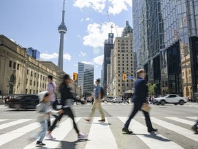 Pedestrians in downtown Toronto, Ontario, Canada, on Friday, June 17, 2022. In his eight years as chief executive officer of CIBC, Victor Dodig has turned the lender into one of the country's fastest-growing banks. His next task is convincing investors the change will stick. Photographer: Christopher Katsarov Luna/Bloomberg