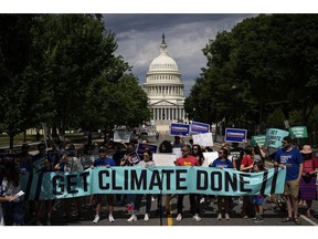 Environmental activists rally near the U.S. Capitol in July.