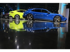 A display of Volkswagen AG electric vehicles, including a Porsche Taycan, right, during the groundbreaking ceremony for the SalzGiga fuel cell gigafactory, operated by Volkswagen Group Components, in Salzgitter, Germany, Thursday, July 7, 2022. VW's future battery hub in Salzgitter will begin production in 2025 for the company's volume cars.