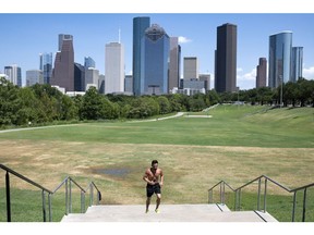 A runner jogs up stairs at Buffalo Bayou Park during a heatwave in Houston, Texas, US, on Monday, July 11, 2022. Texas residents and businesses, including the biggest names in oil, autos and technology, are being asked to conserve electricity Monday afternoon during a heatwave that's expected to push the state's grid near its breaking point. Photographer: Mark Felix/Bloomberg