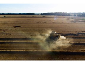 A combine harvester cuts through a field of wheat during summer harvest in Heudicourt, France, on July 14.