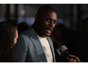 Idris Elba speaks to a reporter at the