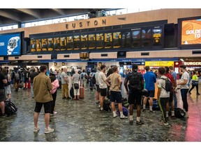 LONDON, ENGLAND - JULY 30: Rail passengers wait for announcements at Euston train station on July 30, 2022 in London, United Kingdom. ASLEF Union says that train drivers have not had a pay rise since 2019 and coupled with inflation expected to rise to 11% this Autumn, it amounts to a substantial pay cut.