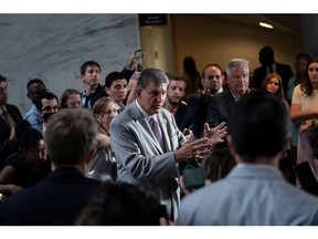 Senator Joe Manchin, a Democrat from West Virginia, center, speaks during a news conference on Capitol Hill in Washington, D.C., US, on Tuesday, Aug. 2, 2022. Republicans are using an obscure rule named for the Senate's longest-serving member to challenge provisions of the Democrats' surprise tax, health and climate deal in the hopes of whittling down the legislation.